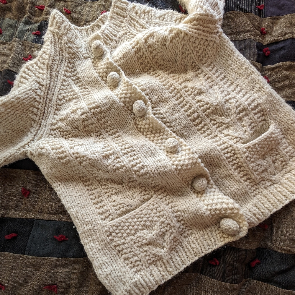 Chunky hand knit ivory wool sweater with pockets and buttons